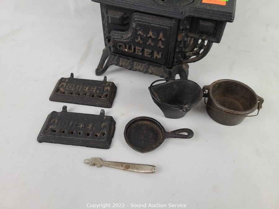 Sold at Auction: QUEEN MINIATURE CAST IRON STOVE W PANS