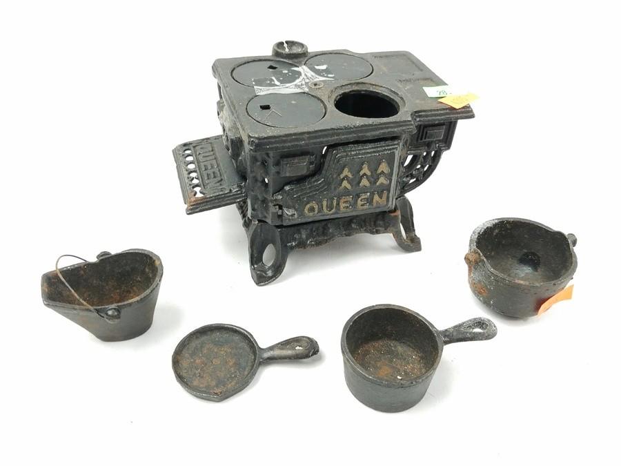 Sold at Auction: QUEEN MINIATURE CAST IRON STOVE W PANS